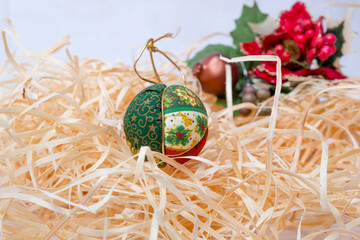 Christmas decoration balls on a straw background.