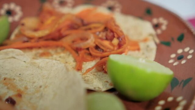 Vegan Mexican tinga tacos on traditional clay plate