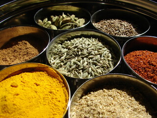 Indian spices, close up, fennel seed, turmeric, coriander, cumin seeds, chile pepper, cardamom pods,