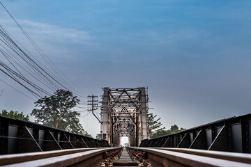 Old railroad tracks on Black Bridge or Lampang Railway Bridge. Railway bridge on river at Lampang thailand. Selective focus.