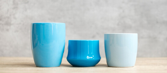 Blue coffee cup and tea mug on wood table background in the morning, Blank copy space for text. International coffee day and daily routine concept