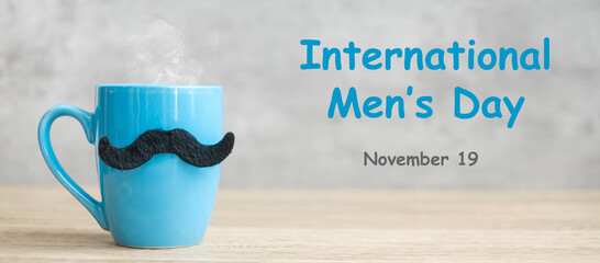 International Men day with Blue coffee cup or tea mug and Black mustache decor on table. Happy...