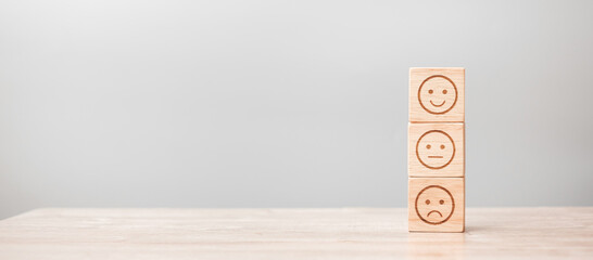 emotion face symbol on wooden blocks. Service rating, ranking, customer review, satisfaction,...