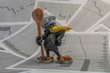 Crow chef on the background of stock price charts. The symbol of manipulation in stock trading. The...