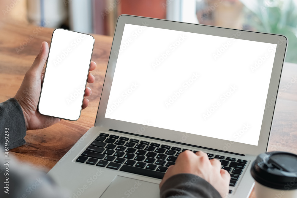 Poster mockup copy space computer notebook laptop and smartphone concept, man hand using a laptop on intern