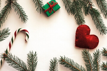 New Years decorations on a white background. Christmas heart, caramel and gift box