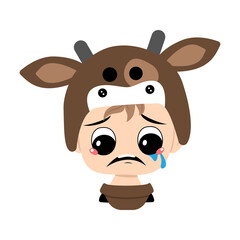 Boy with blonde hair and crying and tears emotion, sad face, depressive eyes in cow hat. Head of cute child with melancholy expression in carnival costume for the holiday, Christmas or New year