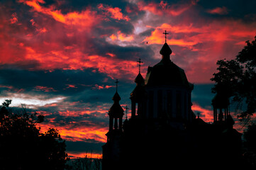 Religious church building silhouetted. Red majestic sky