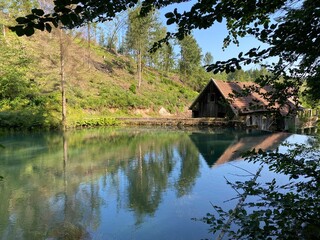 Obraz premium Remains of an old sawmill on the small dam of Čogrljevo Lake in the mountain hamlet of Tići - Gorski kotar, Croatia (Ostaci stare pilane na maloj brani Čogrljevog jezera u goranskom zaselku Tići)