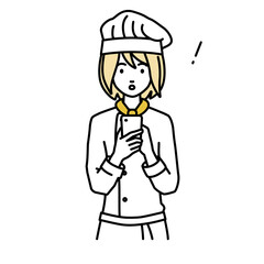 立ってスマートフォンを操作して何かに気づいて驚いた調理師の女性