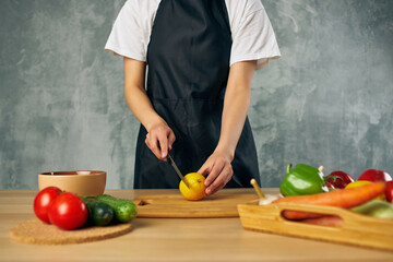 Woman in black apron lunch at home vegetarian food salad diet