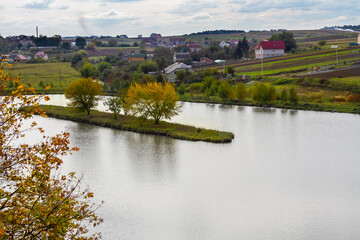 Fototapeta na wymiar Lake near the village in Ukraine, autumn day