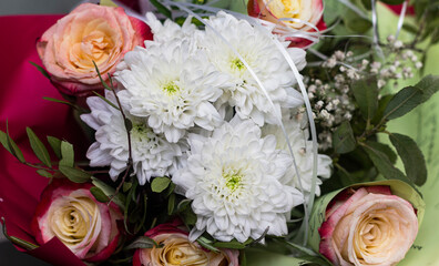 Roses and chrysanthemums in the bride's bouquet. Delicate flowers in a bouquet