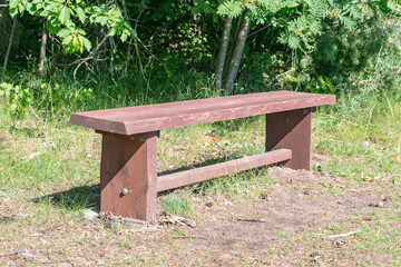 Empty simple wooden bench in the park.