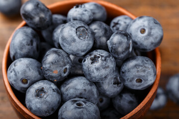 Freshly picked blueberries in a clay bowl. Healthy berry, organic food, antioxidant, vitamin