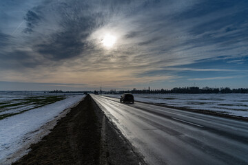 Icy road in sunny winter day.