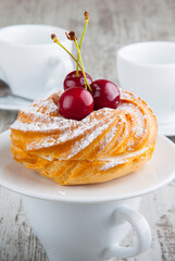 custard dessert with cherry flavor and cherry with a mug