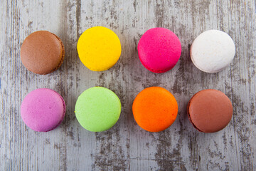 colored macaroon on wooden background