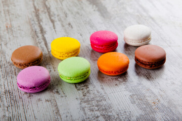 colored macaroon on wooden background