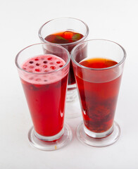 hot berry drinks in a glass glass on a white background