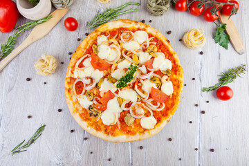 italian pizza on a wooden background with decoration around