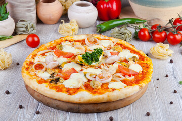 italian pizza on a wooden background with decoration around