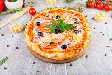 italian pizza on a wooden background with decoration around