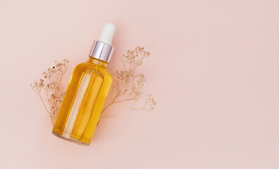 glass bottle with serum on a light background with sun glare