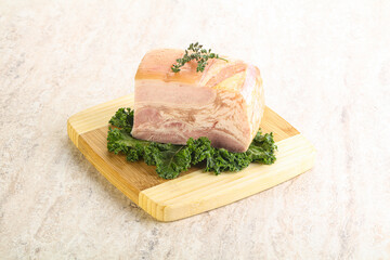 Cut of pork bacon over board