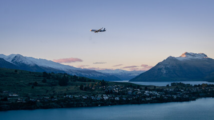 Air NZ Plane flying above Lake Wakatipu during sunset. July 2021, Queenstown, New Zealand