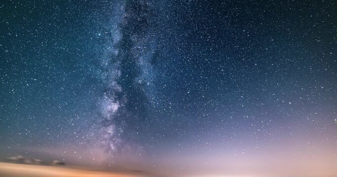 Milky way galaxy stars in starry sky background with fast clouds motion, Astronomy Time lapse Night to day