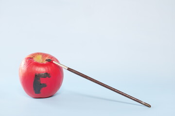 Fake food, coloring, fraud and fraudulent food concept. Apple painted red.