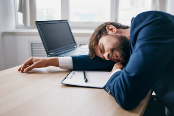 businessmen in the office at the desk in front of a laptop career technologies