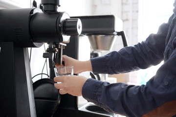 Grinding coffee beans into a cup