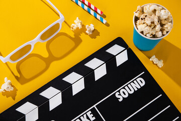 3D glasses, popcorn in a box, clapper board,