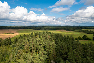 Fototapeta na wymiar Aerial view of green islands and clouds at summer sunny day. Masurian Lake District in Poland. 