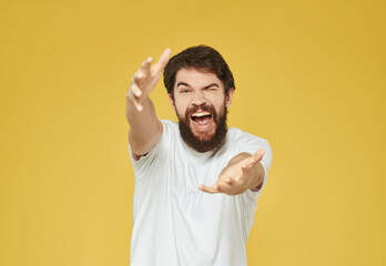 bearded man in a white t-shirt irritated facial expression Lifestyle