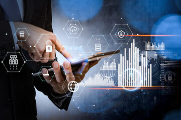 Businessman with tablet device, white hologram foreground with glowing information security icons...