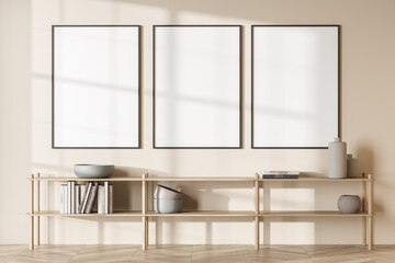Three empty canvases on beige living room wall
