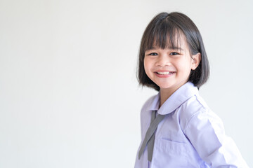 Portrait of a cheerful child student isolated on white background smiles and looks at the camera. Back to School Concept Stock Photo