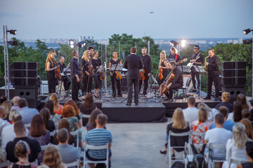 Orchestra performing live concert on the street - obrazy, fototapety, plakaty