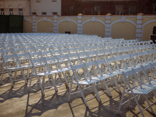 White chairs for concert viewers on the street