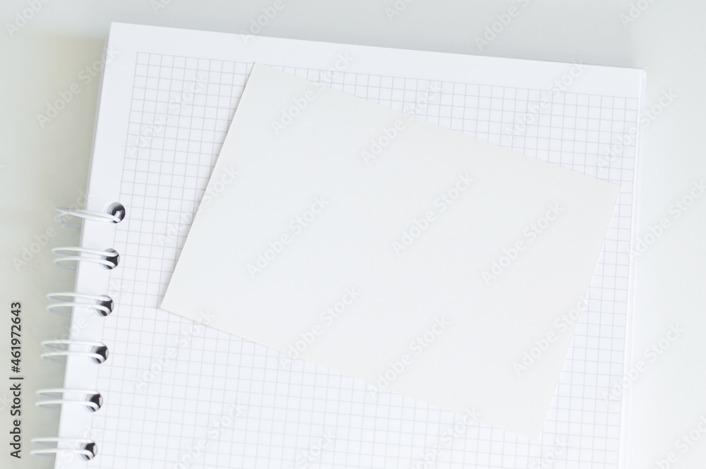 Poster blank notepad with white sheet for notes on the table.