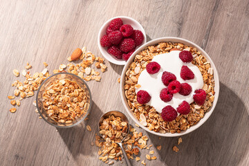 Sweet breakfast with granola, yogurt and fresh raspberries