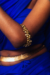 portrait of dark skinned Indian woman from Malaysia against a dark blue background