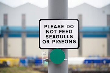 Do not feed seagulls or pigeons sign on private land fence