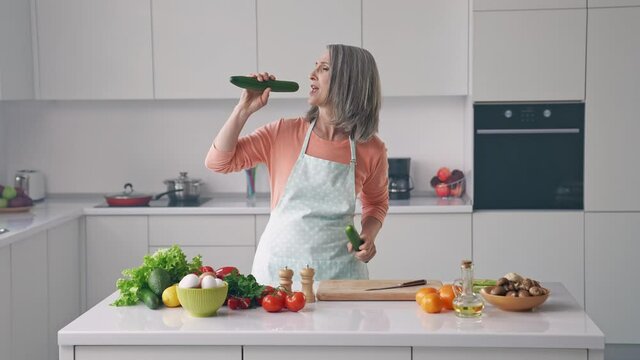 Crazy grandma cook salad hold cucumber mic sing karaoke song kitchen disco dance