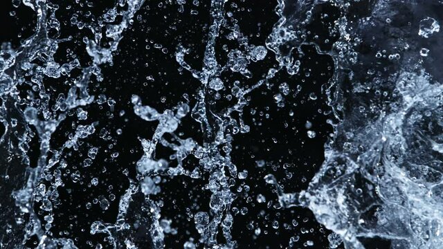 Super Slow Motion Shot of Side Water Splash Isolated on Black Background at 1000fps.