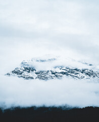 Fototapeta na wymiar The slopes of the mountains in the fog