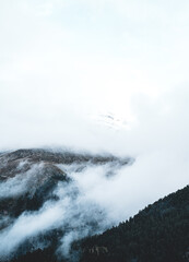 Naklejka premium The slopes of the mountains in the fog